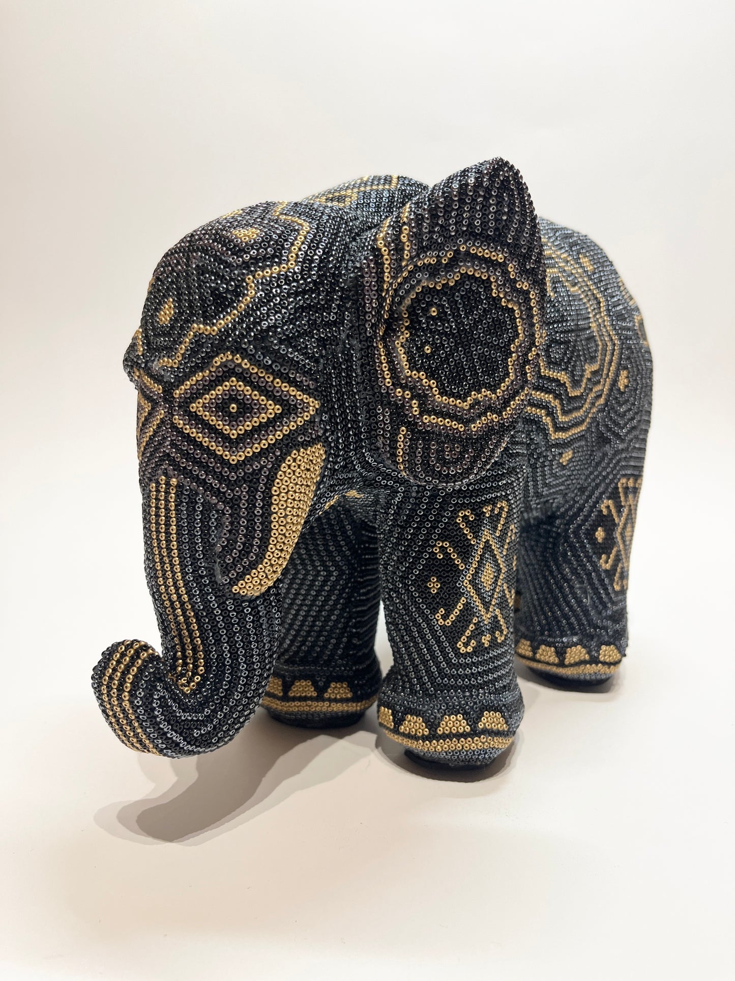 Large elephant black gray and gold elephant