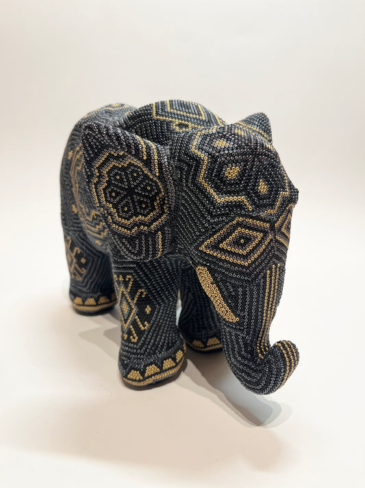 Large elephant black gray and gold elephant