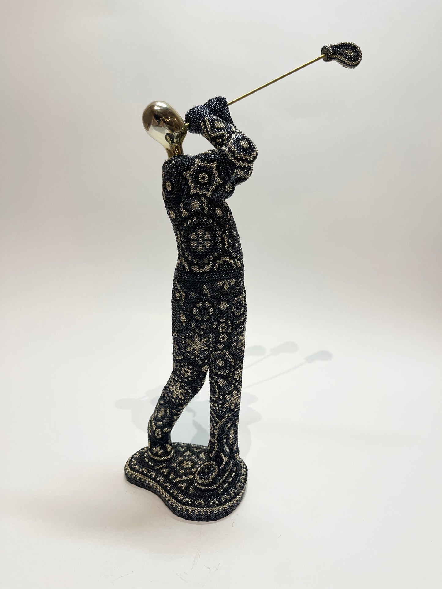 Golfer swinging statue black and silver